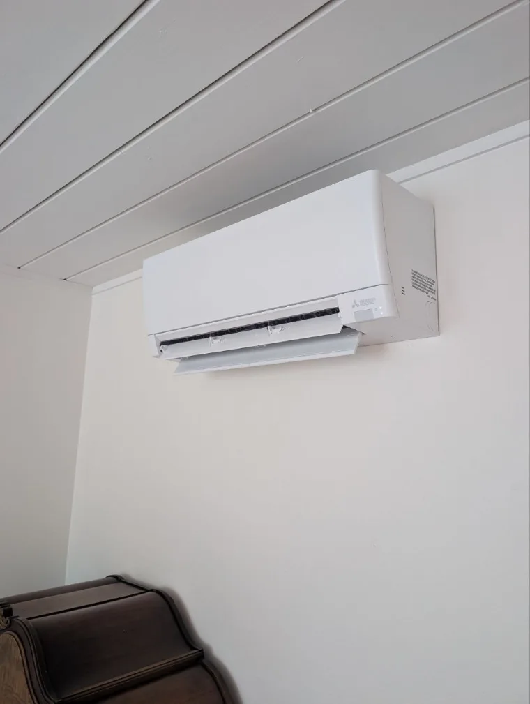 Ductless mini-split head Sunny fitted on the wall of a room with no ductwork
